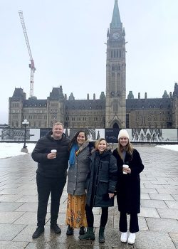 Bastarache moot team in front of Parliament buildings in Ottawa left to right Dominique Gibson, Trusha Dash, Seth Lozinski, Marie Boyd