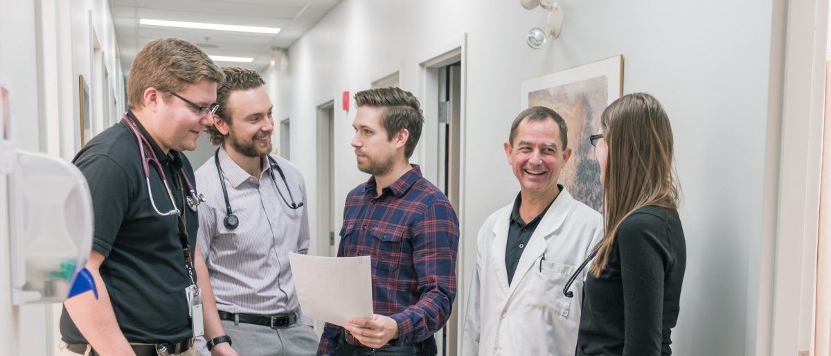 Physicians chatting in a hallway.