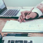 Two staff members work together closely on a plan.