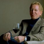 Man sitting with a glass of wine