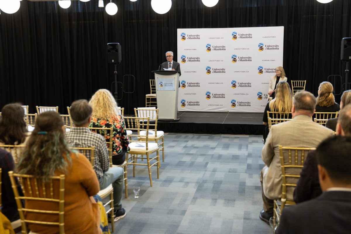 President Michael Benarroch speaking on stage the Faculty Recognition Reception 2023.