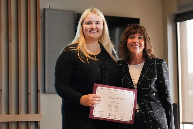 Laurie Schnarr, Vice-Provost (students) and Makenna Coldwell Engineering Student and 2024 Student Affairs Participation Award recipient, stand for a photo on stage with the award.