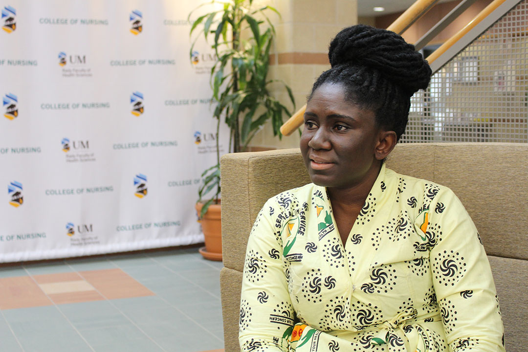 Vera Anokyewaa Amponsah sitting in the College of Nursing building, looking thoughtful.