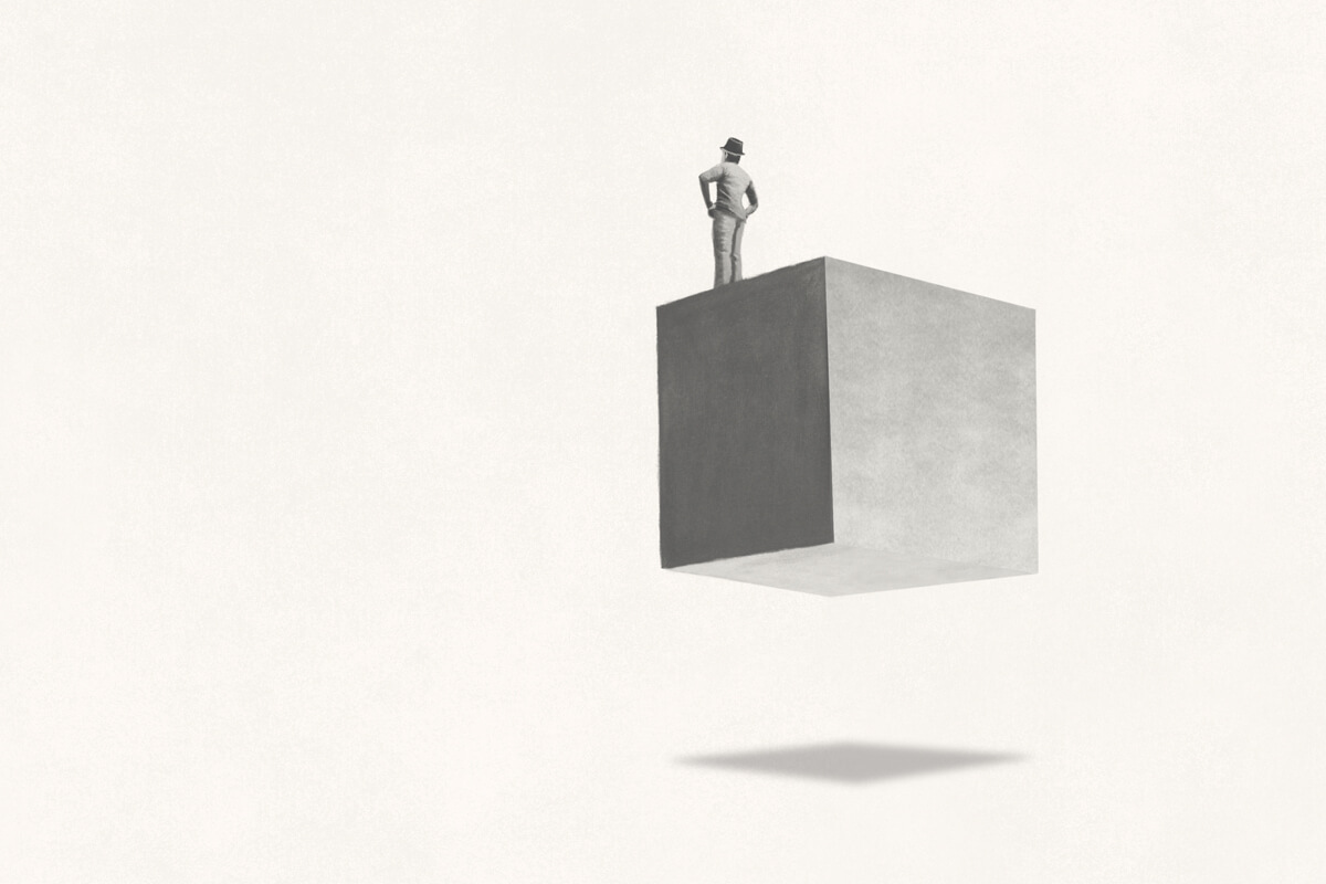 Conceptual illustration of a man standing on a floating cube.
