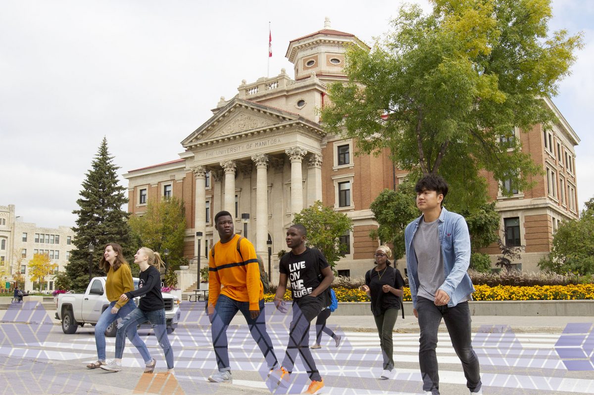 Students walk across the crosswalk in front of the administration building.