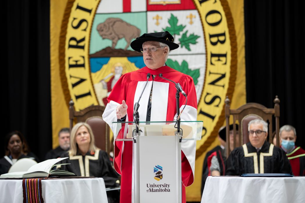 Dr. Thomas Quinn speaking at the podium at Convocation.