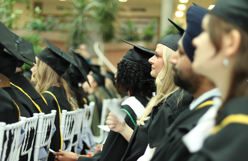 Dentistry students wear graduation caps and gowns at the convocation ceremony.