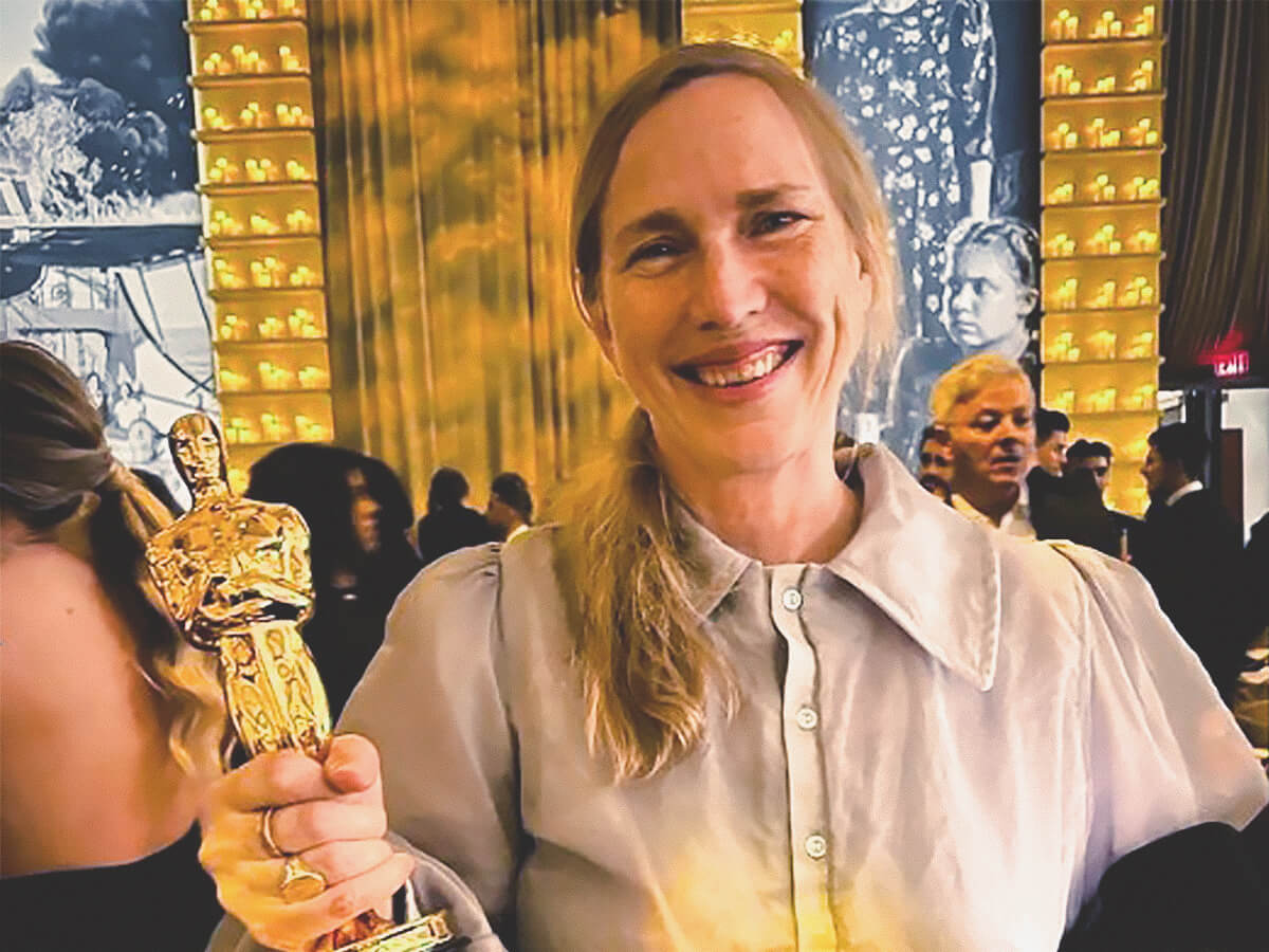 Miriam Toews holds Sarah Polley's Oscar for Best Adapted Screenplay