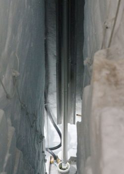 Ice core drill in between ice slabs.