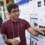 Seyed Mojtaba Hosseini pointing to his research poster