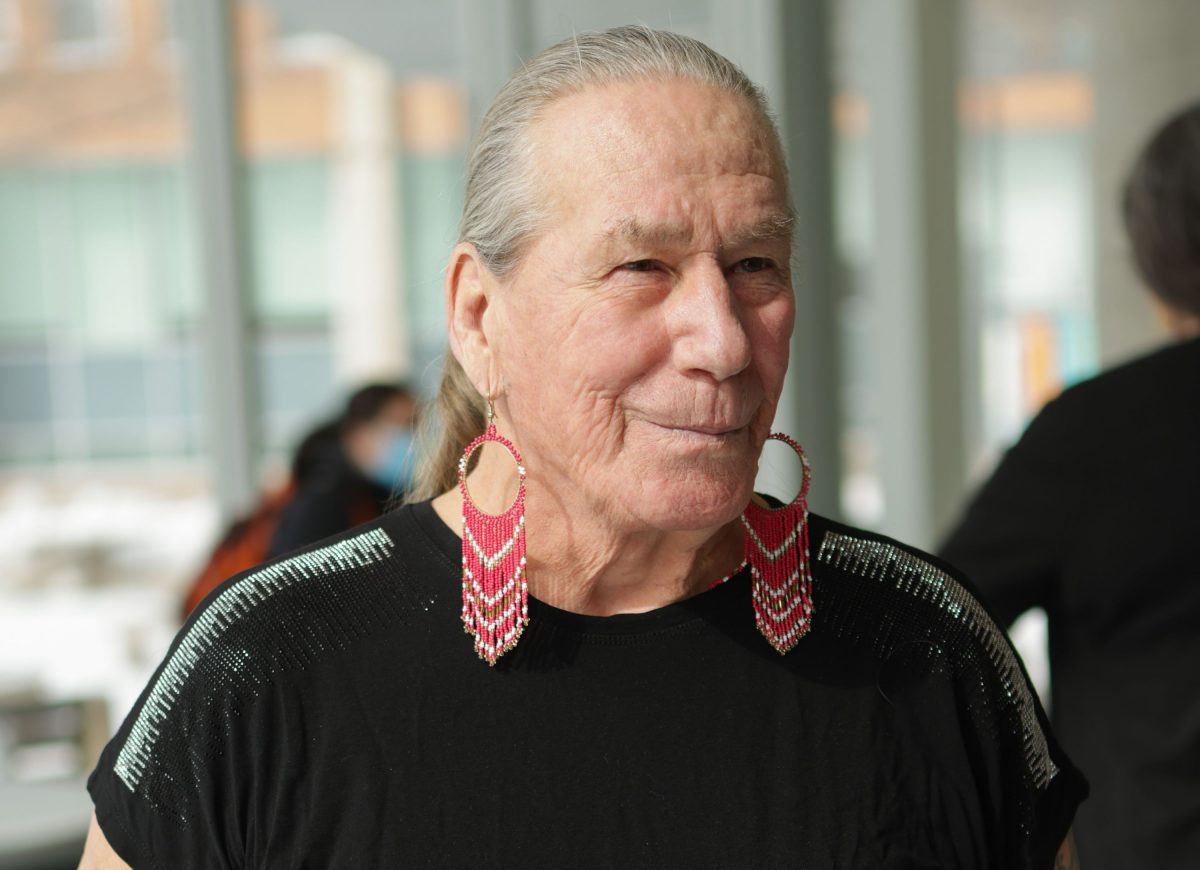 Two-Spirit Métis Elder Charlotte Nolin poses for a photo at an event.