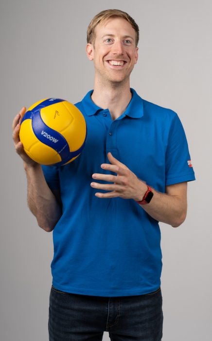 Photo of Chris Voth holding a volleyball.