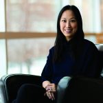 Profile of Christine Leong sitting in a chair.