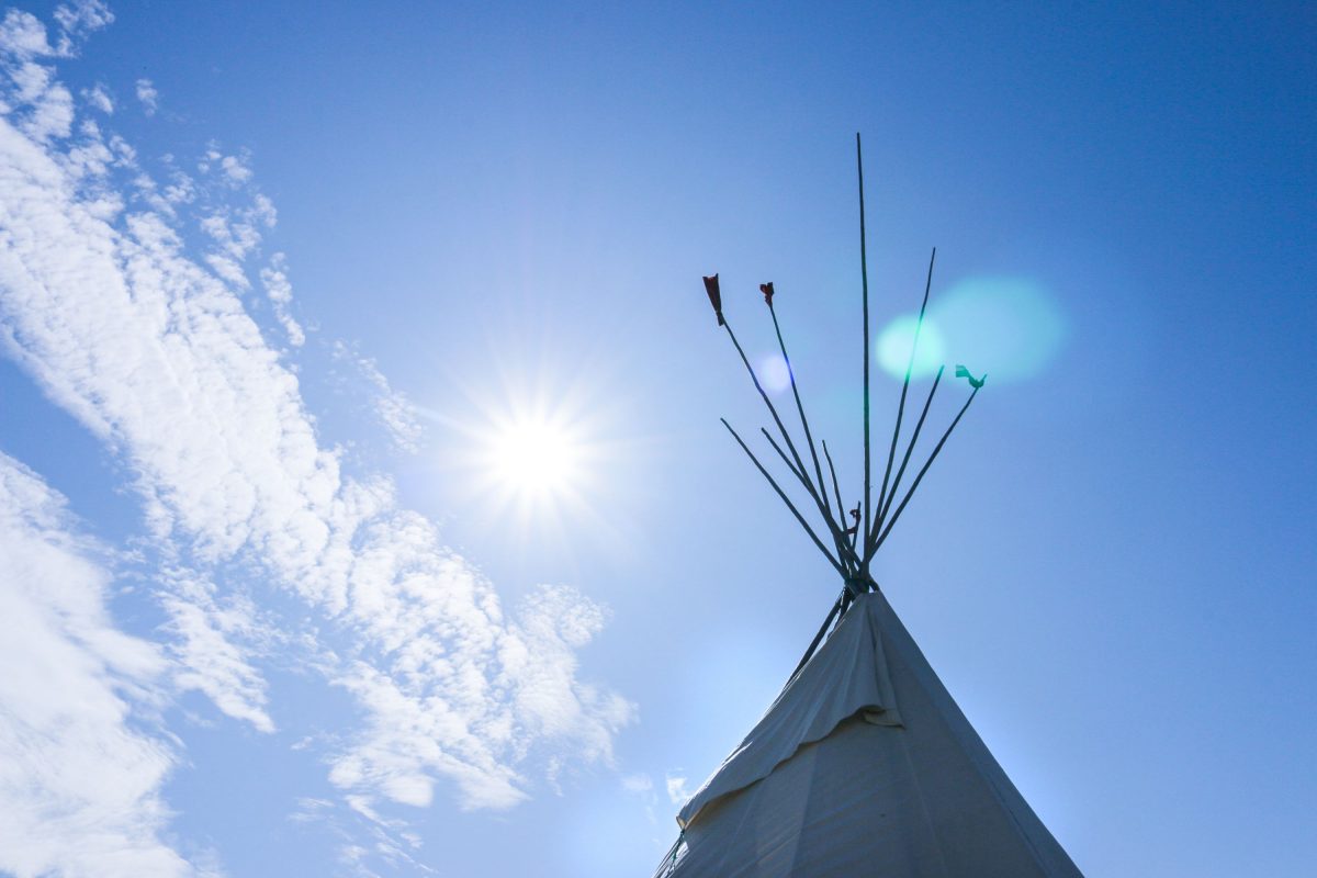 tip of a teepee shown against a bluesky