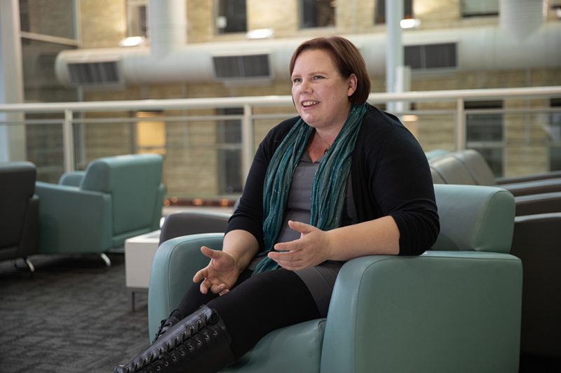 Lisa Engel talks while sitting on a chair at Banntyne Campus.