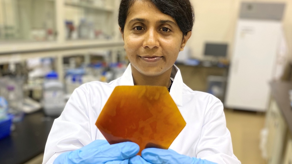 UM researcher Thilini Dissanayake holds up a canola-based product that could replace plastic.