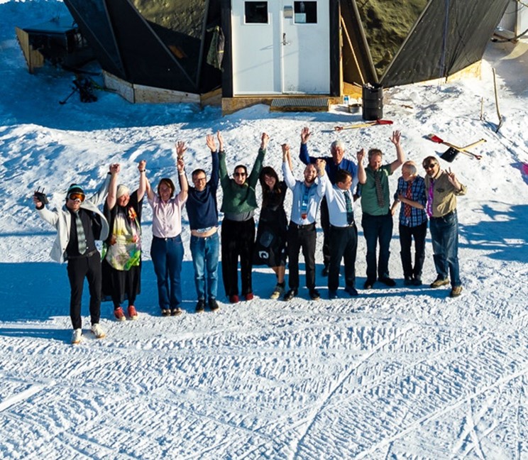 Dorthe Dahl-Jensen and team of international researchers celebrate in the snow in Greenland
