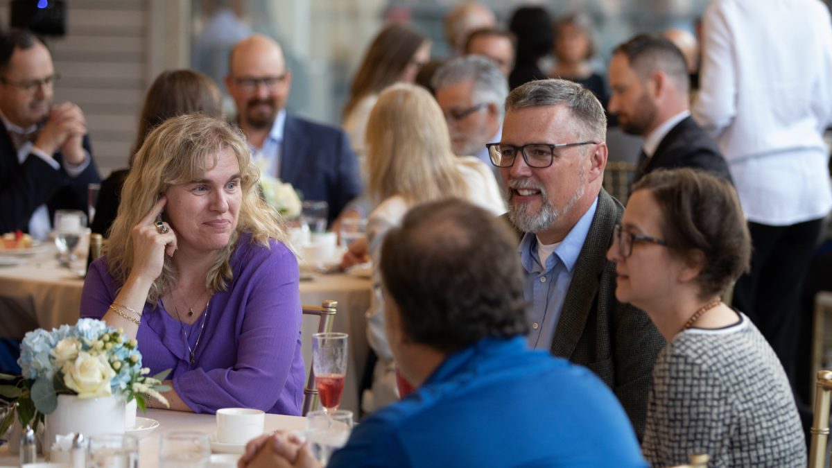 Faculty and staff around a table at the 2023 Long Service Awards.