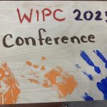 Conference sign with children's painted handprints