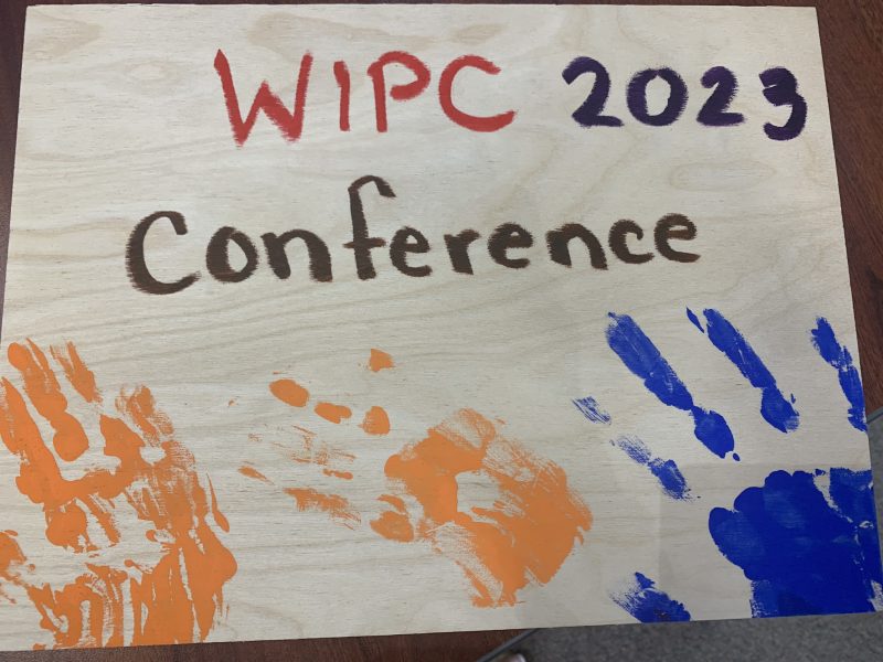 Conference sign with children's painted handprints