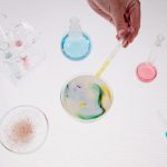 a photo of a laboratory experiment on a glass with colours