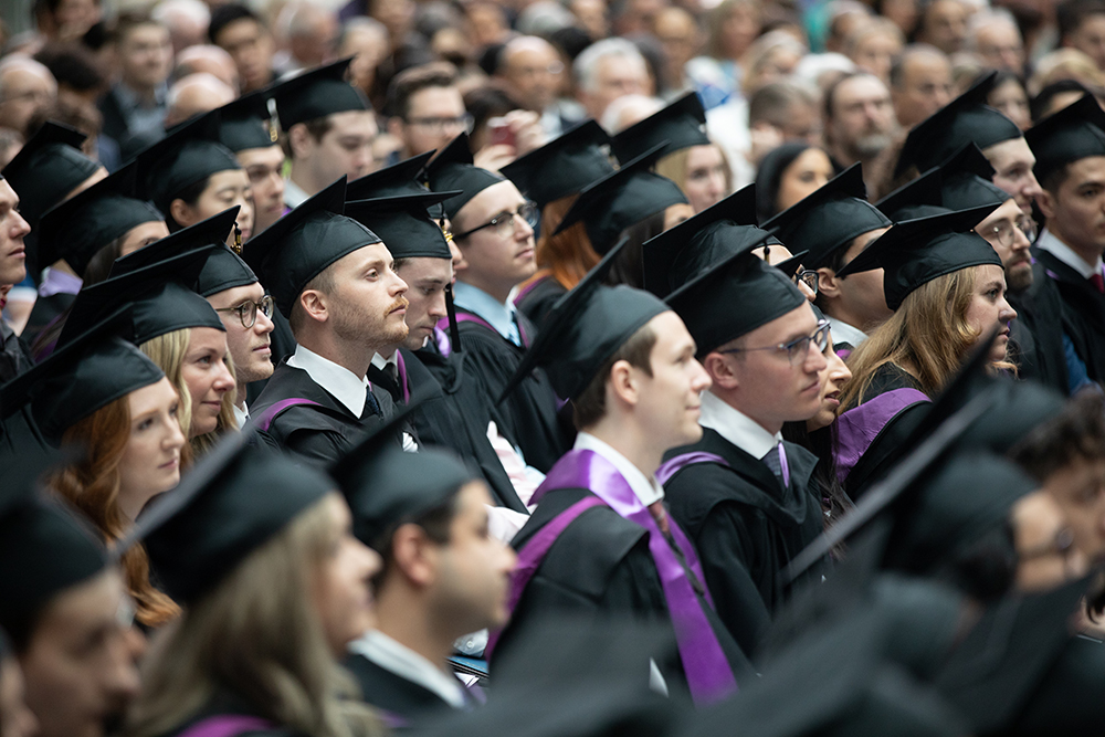 Students wearing caps and gowns at convocation.