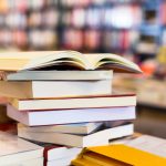 Stack of books on a table in a bookstore.