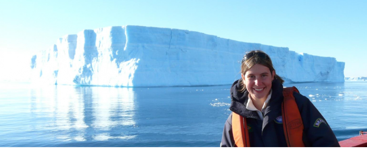 image of UM researcher Juliana Marson in front of a iceberg