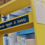 yellow shelving displaying a sign that reads environmental health and safety