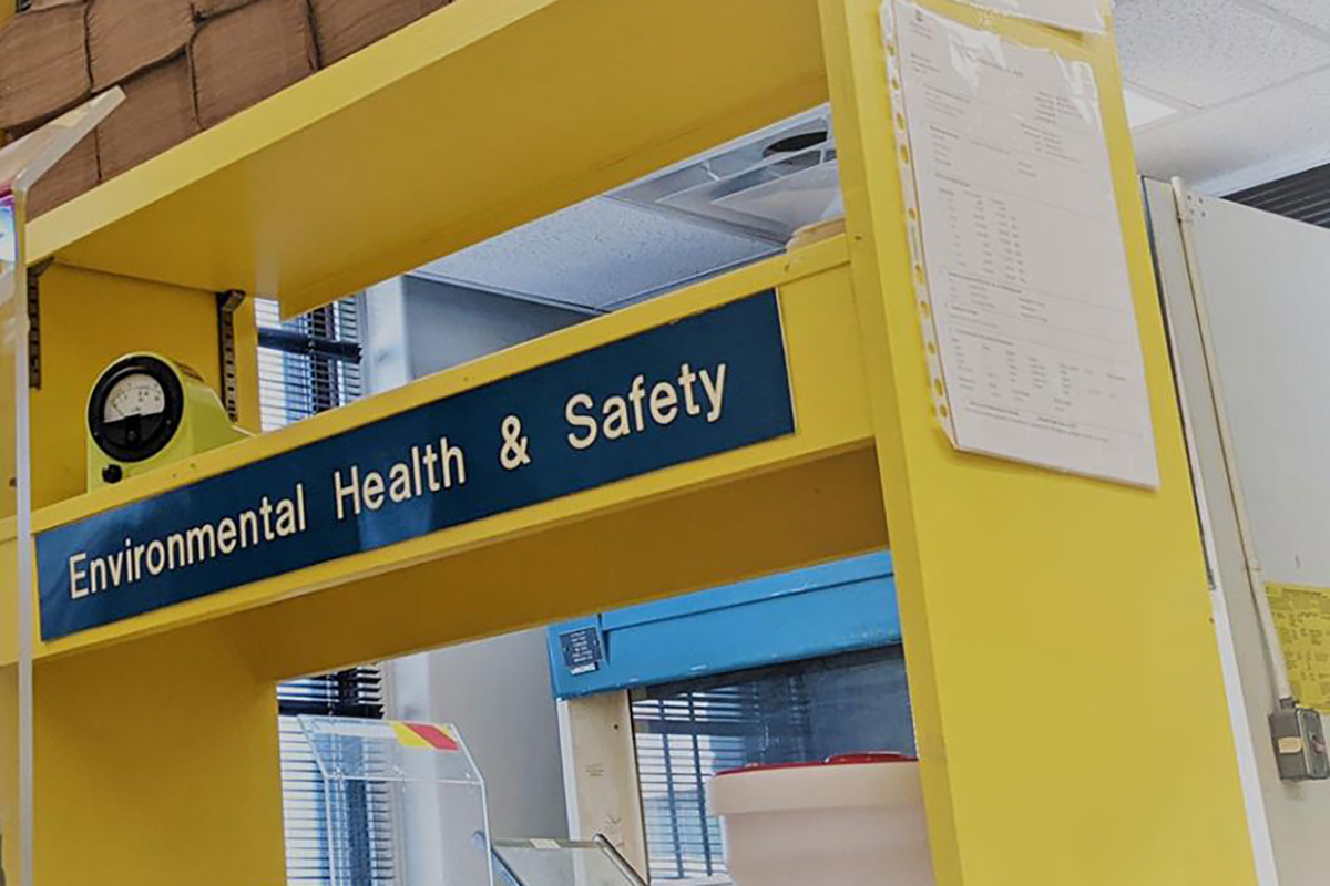 yellow shelving displaying a sign that reads environmental health and safety