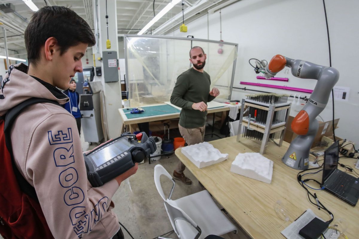 Instructor and student exploring the FabLab in the Faculty of Architecture