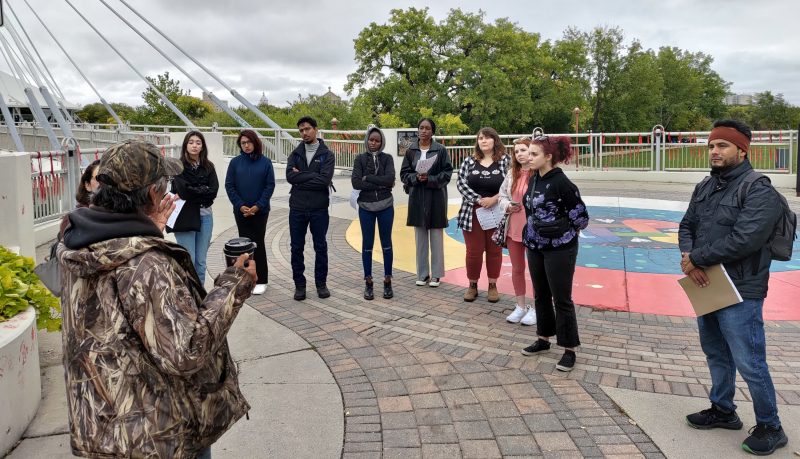 A local participant in a nearby protest that was taking place regarding Missing and Murdered Indigenous Women and Girls, stopped to speak with the new cohort of MHR students on their Tour.