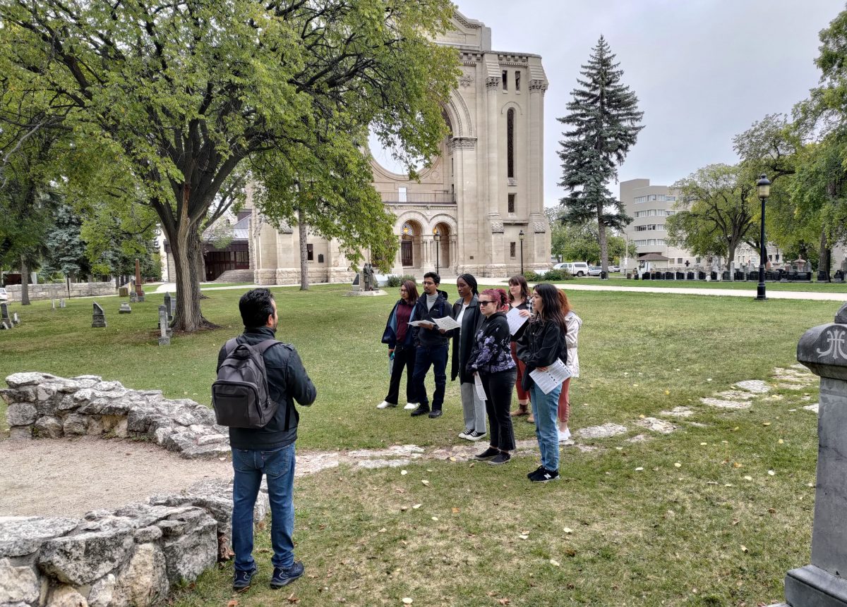 Master of Human Rights students assemble at Louis Riel’s grave in the St. Boniface Cathedral cemetery to start the program’s annual Human Rights Walking Tour of Winnipeg.