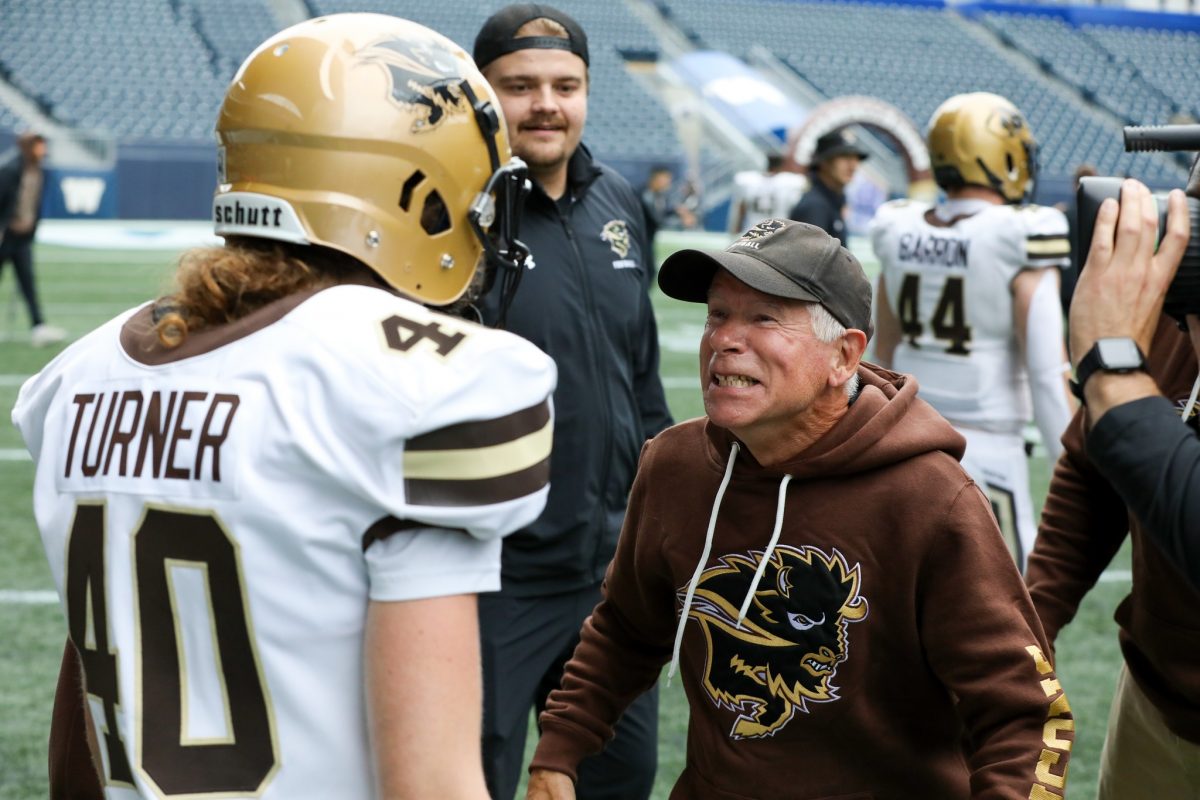 Bisons Kicker Maya Turner and Coach Brian Dobie at history-making game, where she became the first woman to play and score in Canadian U sports.