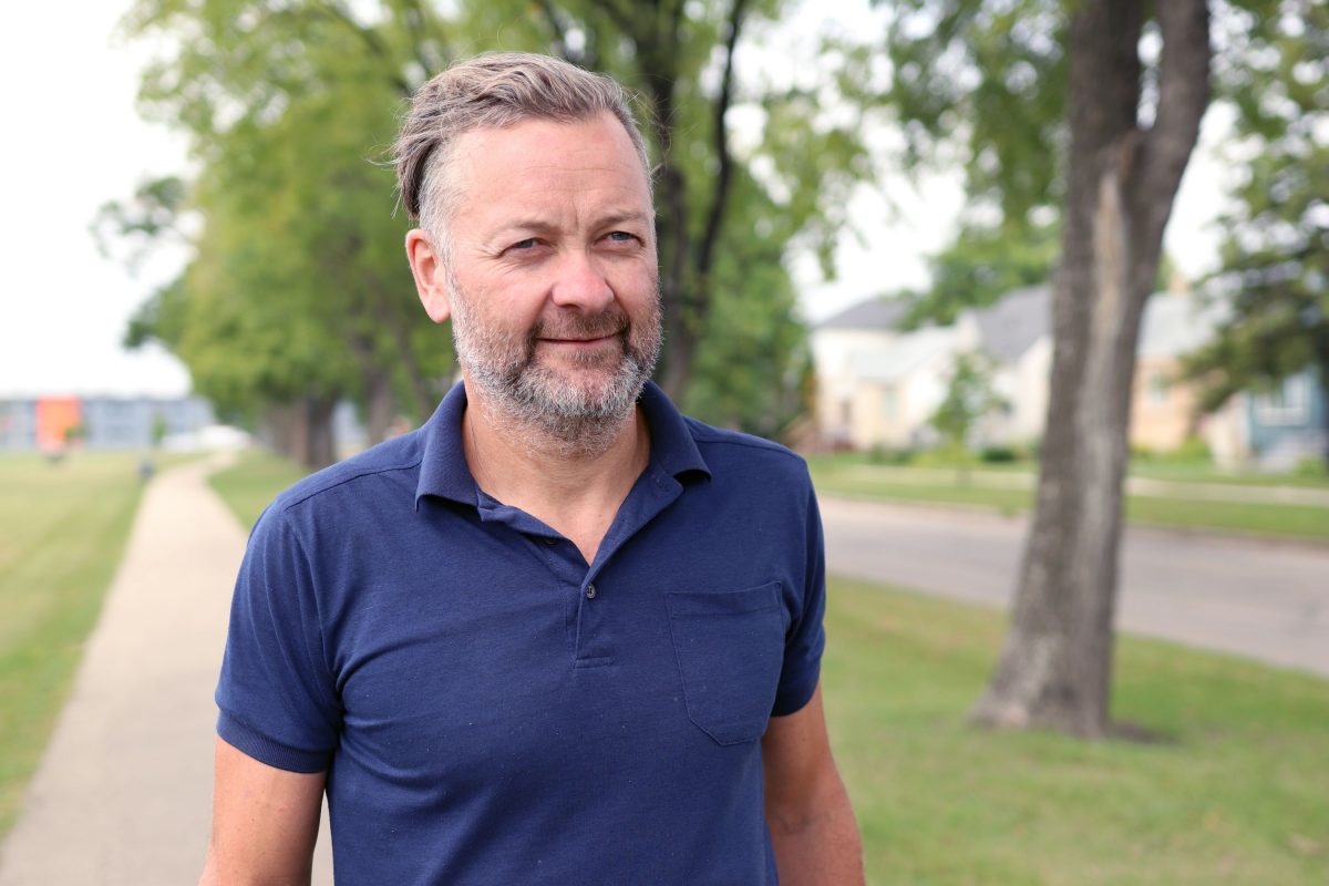 Dr. Jonathan McGavock walks on an outdoor pathway.