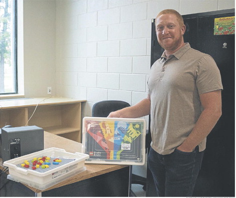 Michael Barker holding a Lego set