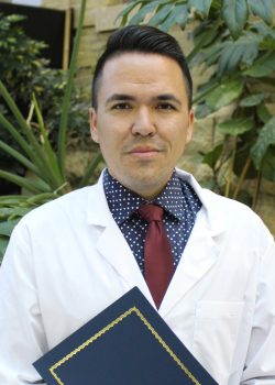 Portrait of Cody Magun. He is wearing a white coat. 
