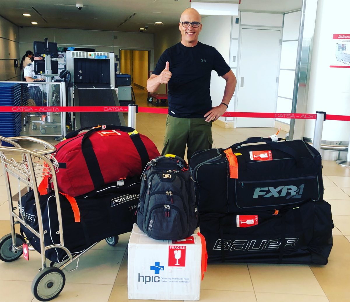 Gordon Giesbrecht standing inside the Winnipeg airport preparing to depart for Ukraine.