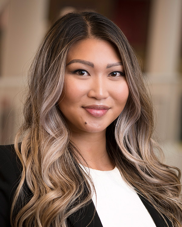 Sheena Gee smiles in a headshot.