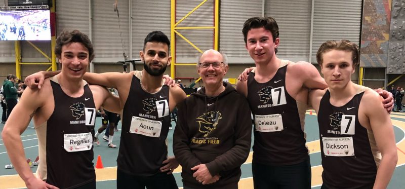 Alex Gardiner poses with a relay team on the track