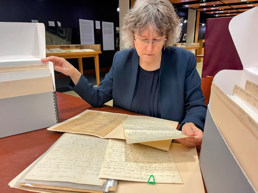 Shelley Sweeney looks over the Peter Hugh Aykroyd fonds in the University of Manitoba archives and special collections room. (Darren Bernhardt/CBC)