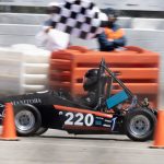 electric race car crossing finish line