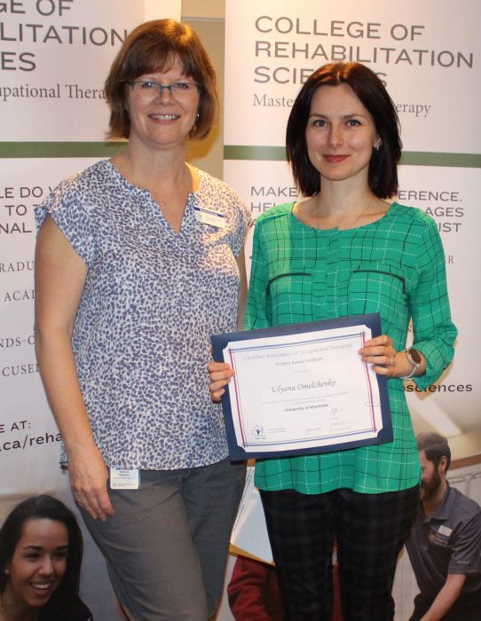 Ulyana Omelchenko accepts an award from Brenda Semenko from the Canadian Association of Occupational Therapists.
