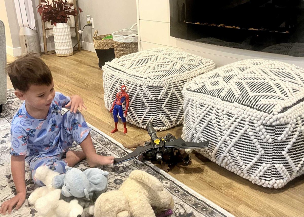 child playing with toys on the living room floor