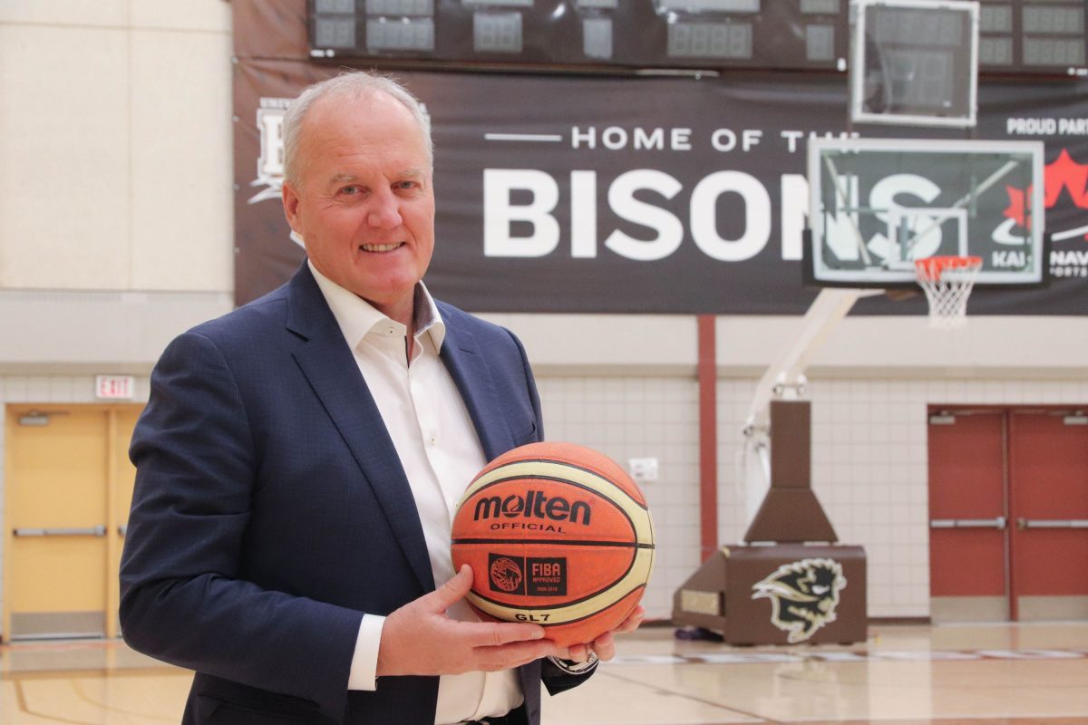 Allan Edie in front of the Bisons basketball court
