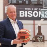 Allan Edie in front of the Bisons basketball court