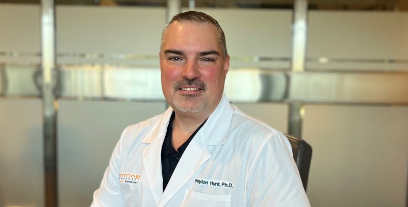 Dr. Waylon Hunt wearing a white lab coat.