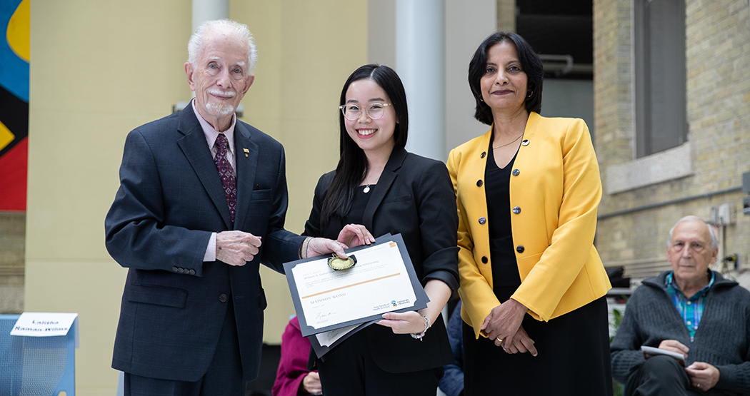 Student award winner with college dean and award donor.