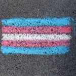 transgender flag coloured on sidewalk