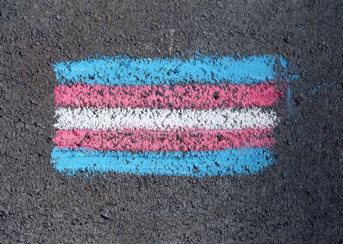 transgender flag coloured on sidewalk